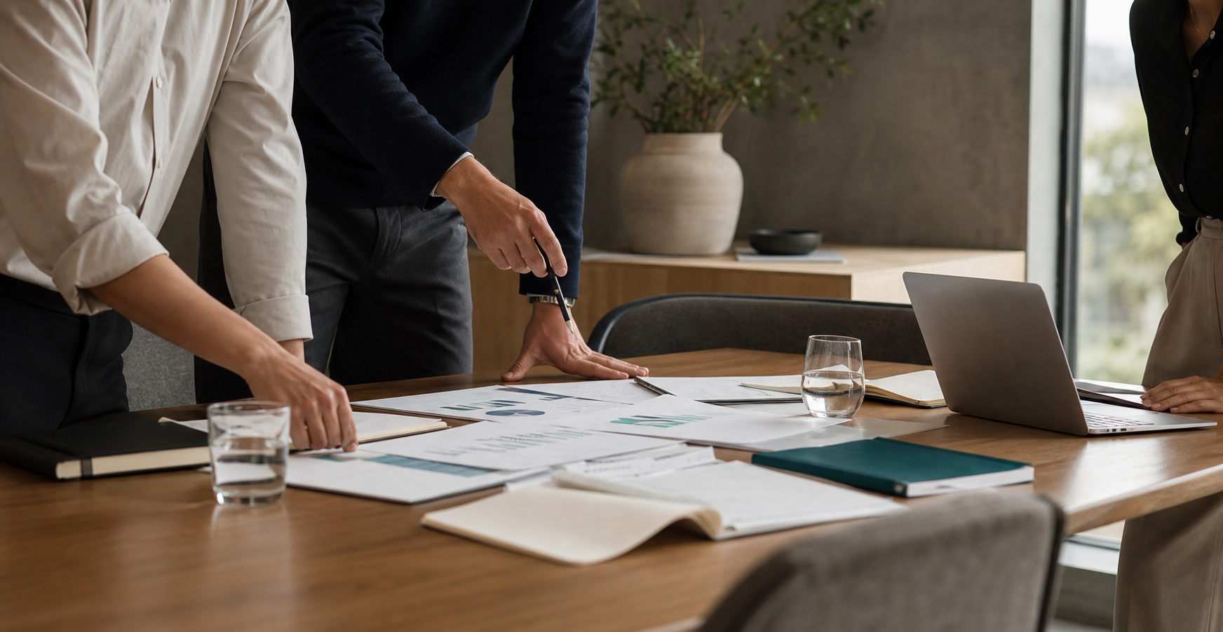 Consultants reviewing strategy documents around a meeting table.